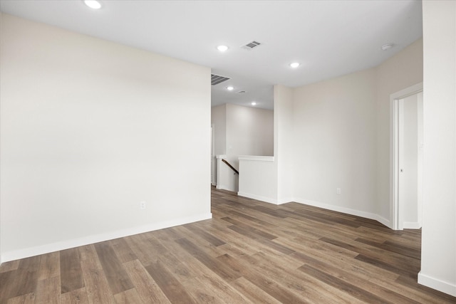 525 Galt Dr, Stephenville, TX 76401 - unfurnished room featuring wood finished floors, baseboards, visible vents, and recessed lighting