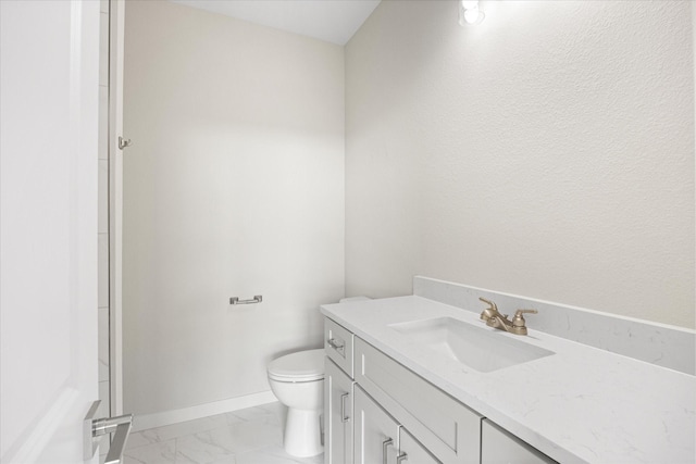 525 Galt Dr, Stephenville, TX 76401 - bathroom featuring toilet, marble finish floor, baseboards, and vanity