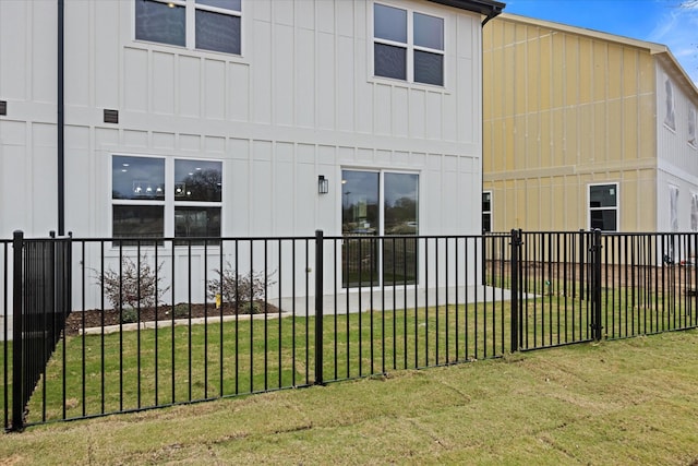 525 Galt Dr, Stephenville, TX 76401 - rear view of property with board and batten siding, fence, and a lawn