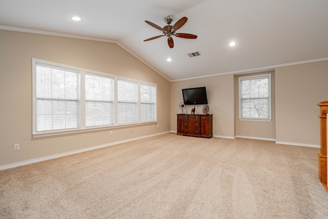 unfurnished living room with ornamental molding, light carpet, a ceiling fan, visible vents, and lofted ceiling