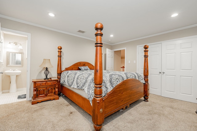 bedroom featuring crown molding, ensuite bath, visible vents, and carpet floors