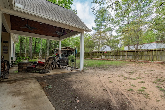 view of yard with a patio area, a fenced backyard, and a ceiling fan
