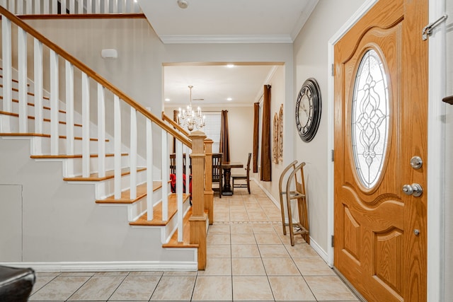 entrance foyer featuring crown molding, light tile patterned floors, stairway, a chandelier, and baseboards