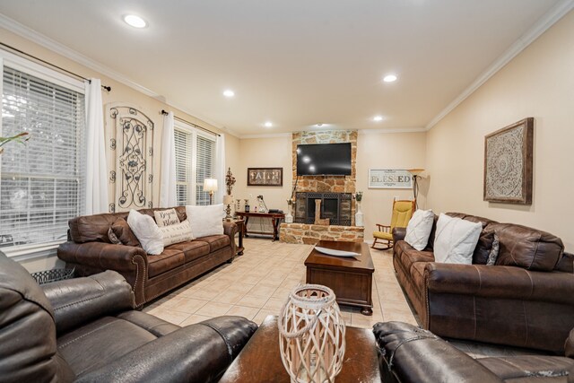living area featuring crown molding, a stone fireplace, recessed lighting, and light tile patterned flooring