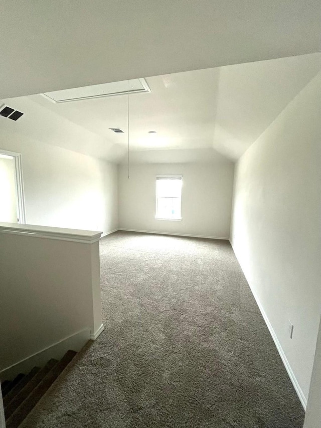 bonus room with carpet flooring, baseboards, attic access, and visible vents
