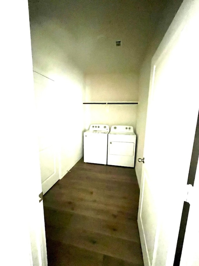 washroom featuring laundry area, wood finished floors, and washing machine and clothes dryer