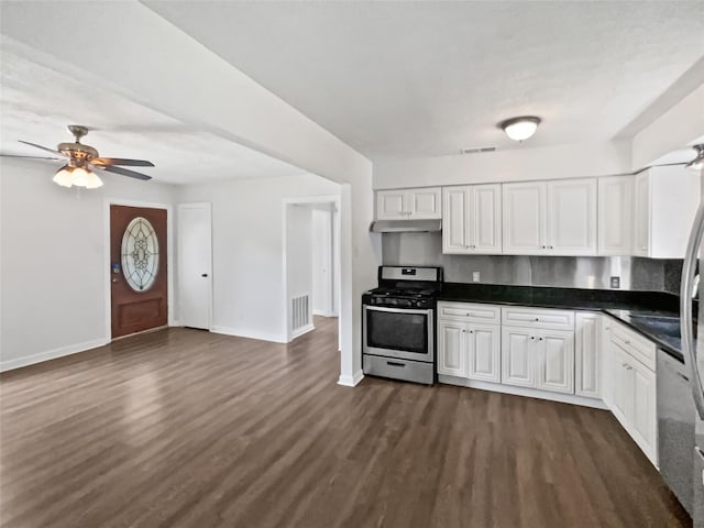 1209 Sylvan Dr, Garland, TX 75040 - kitchen featuring stainless steel gas range, a ceiling fan, baseboards, and white cabinets