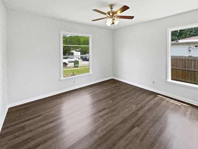 1209 Sylvan Dr, Garland, TX 75040 - unfurnished room with plenty of natural light, dark wood finished floors, and baseboards