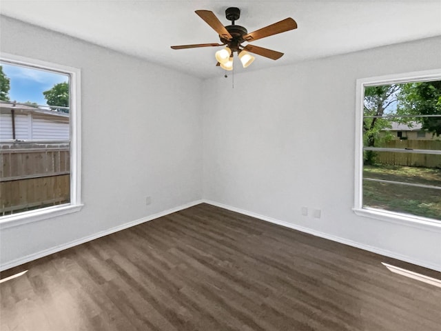 1209 Sylvan Dr, Garland, TX 75040 - unfurnished room featuring dark wood-style flooring, baseboards, and ceiling fan