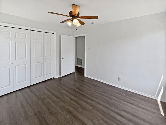 1209 Sylvan Dr, Garland, TX 75040 - unfurnished bedroom featuring baseboards, dark wood-type flooring, a closet, and a ceiling fan