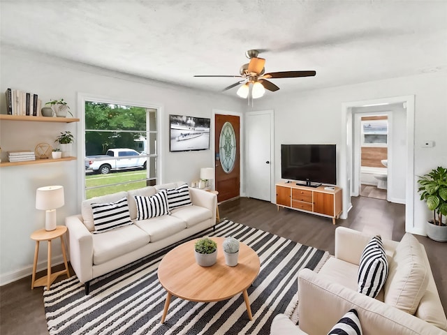 1209 Sylvan Dr, Garland, TX 75040 - living area with a ceiling fan, dark wood-style flooring, and baseboards