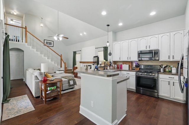 1236 Spanish Moss Dr, Savannah, TX 76227 - kitchen featuring appliances with stainless steel finishes, a ceiling fan, a sink, white cabinetry, and a high ceiling