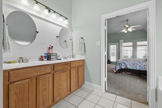 1236 Spanish Moss Dr, Savannah, TX 76227 - ensuite bathroom featuring ceiling fan, tile patterned flooring, double vanity, baseboards, and vaulted ceiling