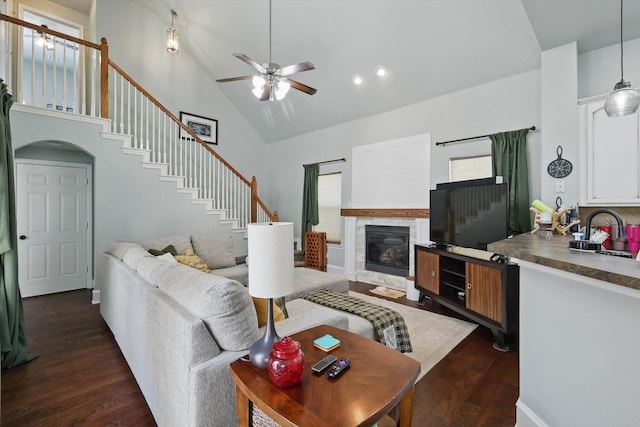 1236 Spanish Moss Dr, Savannah, TX 76227 - living room featuring stairway, high vaulted ceiling, a ceiling fan, dark wood-style floors, and a glass covered fireplace