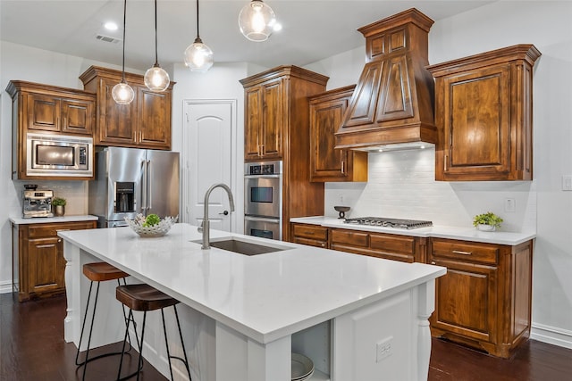 2542 Morgan Ln, Trophy Club, TX 76262 - kitchen with stainless steel appliances, dark wood finished floors, light countertops, a sink, and a center island with sink