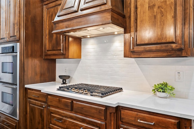 2542 Morgan Ln, Trophy Club, TX 76262 - kitchen featuring stainless steel appliances, backsplash, custom exhaust hood, and light countertops