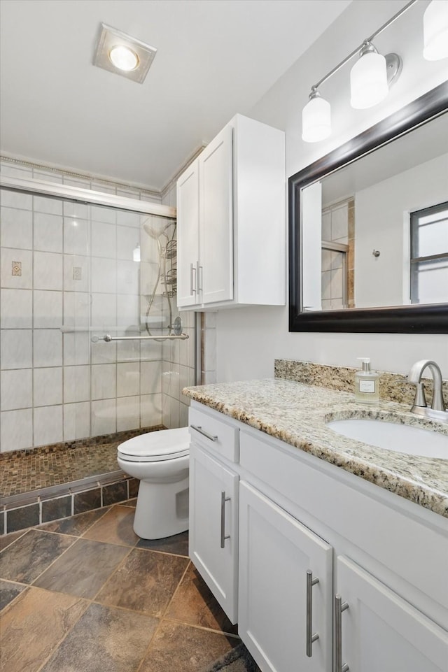 1119 Mockingbird Dr, Grapevine, TX 76051 - bathroom with vanity, a shower stall, toilet, and stone tile flooring