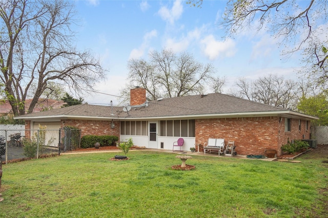 2107 Elizabeth Dr, Brownwood, TX 76801 - back of property with a yard, fence, brick siding, an attached garage, and a chimney