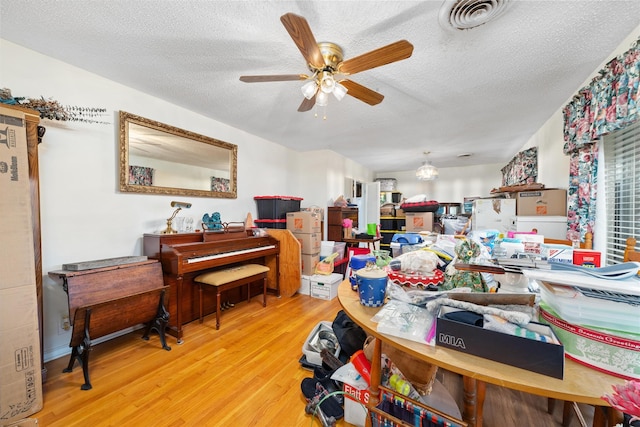 2107 Elizabeth Dr, Brownwood, TX 76801 - interior space with visible vents, a ceiling fan, wood finished floors, and a textured ceiling