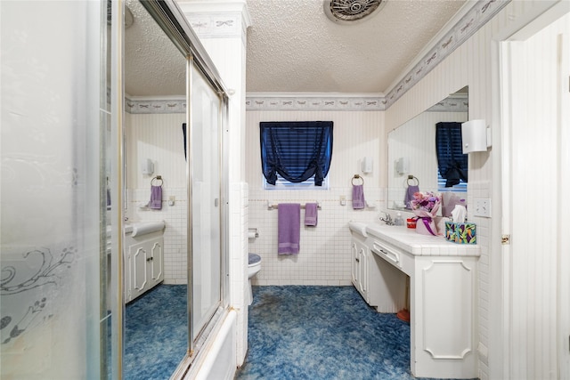 2107 Elizabeth Dr, Brownwood, TX 76801 - bathroom with a textured ceiling, vanity, toilet, an enclosed shower, and wallpapered walls