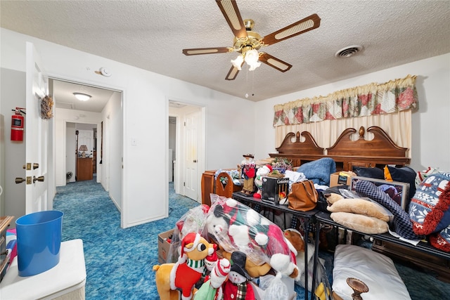 2107 Elizabeth Dr, Brownwood, TX 76801 - bedroom featuring visible vents, ceiling fan, carpet, and a textured ceiling