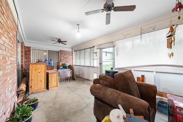 2107 Elizabeth Dr, Brownwood, TX 76801 - living area featuring concrete flooring, ceiling fan, and brick wall