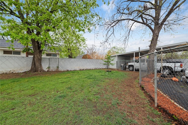 2107 Elizabeth Dr, Brownwood, TX 76801 - view of yard featuring a carport, a pole building, fence, and an outdoor structure