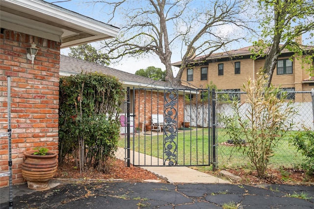 2107 Elizabeth Dr, Brownwood, TX 76801 - view of gate featuring fence and a lawn