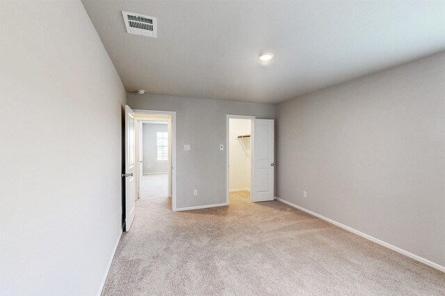 1813 Osage Trl, Mesquite, TX 75149 - unfurnished bedroom with light carpet, a walk in closet, and baseboards