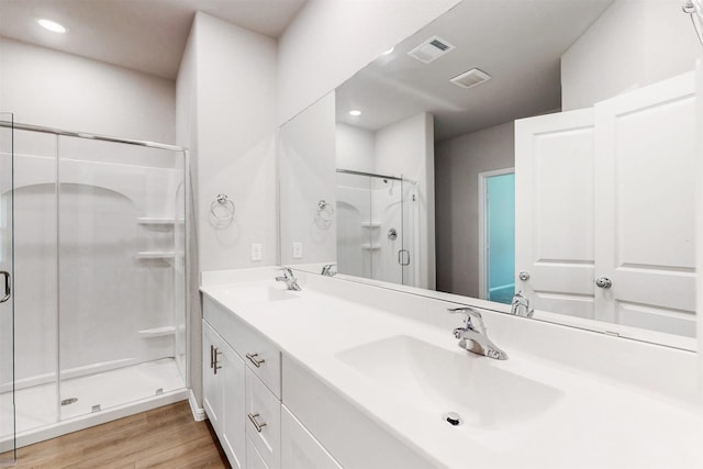 1813 Osage Trl, Mesquite, TX 75149 - bathroom featuring a shower stall, wood finished floors, double vanity, and recessed lighting