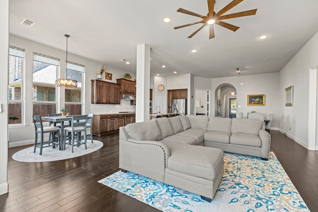 1036 Wedgewood Dr, Forney, TX 75126 - living room with arched walkways, a ceiling fan, dark wood finished floors, baseboards, and recessed lighting