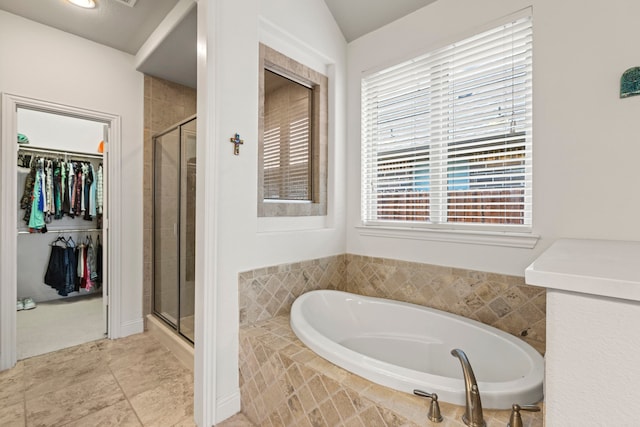 1036 Wedgewood Dr, Forney, TX 75126 - full bath featuring a stall shower, a garden tub, a spacious closet, and healthy amount of natural light