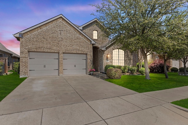1036 Wedgewood Dr, Forney, TX 75126 - view of front of house with brick siding, driveway, a garage, and a front yard
