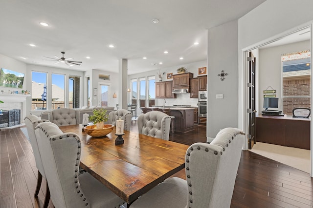 1036 Wedgewood Dr, Forney, TX 75126 - dining space with dark wood-type flooring, ceiling fan, healthy amount of natural light, recessed lighting, and a glass covered fireplace