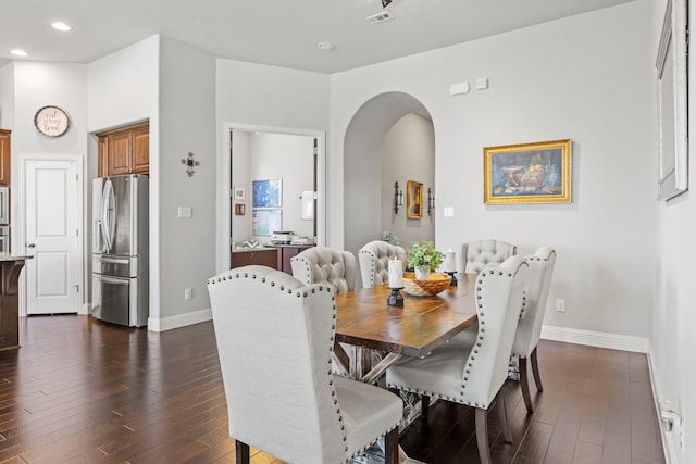 1036 Wedgewood Dr, Forney, TX 75126 - dining room featuring arched walkways, dark wood-type flooring, baseboards, and recessed lighting