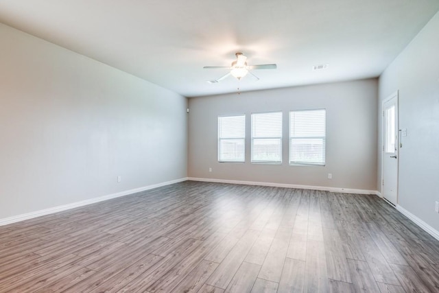 5219 Amistad Ave, Royse City, TX 75189 - unfurnished room with ceiling fan, healthy amount of natural light, wood finished floors, and baseboards