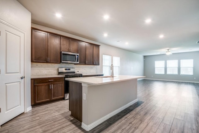 5219 Amistad Ave, Royse City, TX 75189 - kitchen featuring stainless steel appliances, a sink, ceiling fan, backsplash, and light countertops