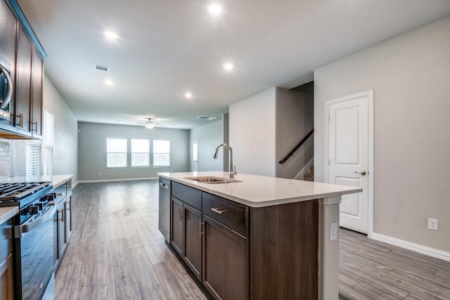 5219 Amistad Ave, Royse City, TX 75189 - kitchen featuring stainless steel appliances, a sink, light countertops, a ceiling fan, and dark brown cabinetry