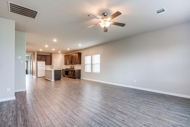 5219 Amistad Ave, Royse City, TX 75189 - unfurnished living room featuring ceiling fan, recessed lighting, wood finished floors, and baseboards