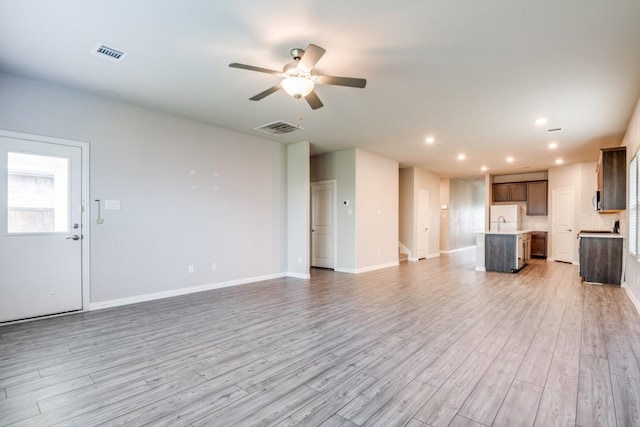 5219 Amistad Ave, Royse City, TX 75189 - unfurnished living room with light wood-style floors, a ceiling fan, recessed lighting, baseboards, and a sink