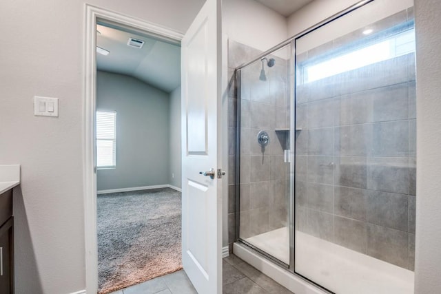 5219 Amistad Ave, Royse City, TX 75189 - bathroom featuring a shower stall, tile patterned floors, vanity, baseboards, and vaulted ceiling