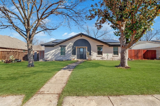4842 Stallcup Dr, Mesquite, TX 75150 - view of front of property featuring fence, solar panels, brick siding, and a front yard