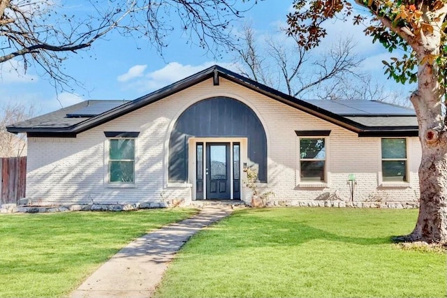 4842 Stallcup Dr, Mesquite, TX 75150 - view of front of house featuring a front lawn, brick siding, solar panels, and fence