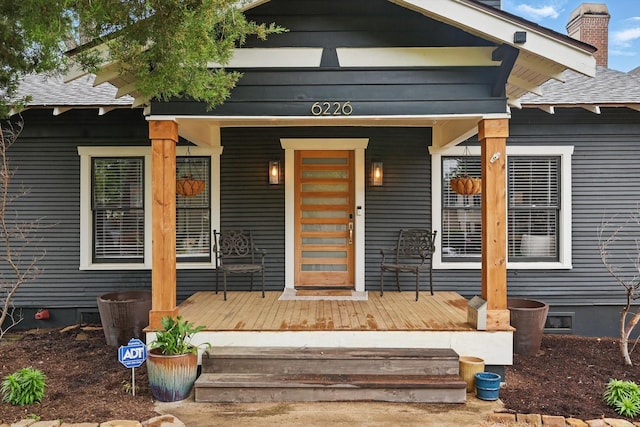 property entrance with a porch and a chimney