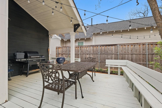 wooden terrace featuring fence