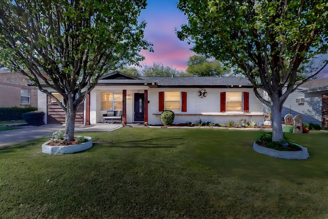 ranch-style home featuring a lawn