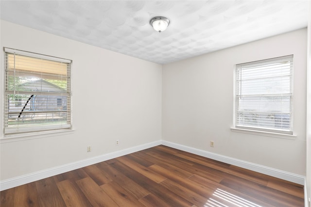 4109 Timberline Dr, Garland, TX 75042 - unfurnished room featuring baseboards and dark wood-style floors