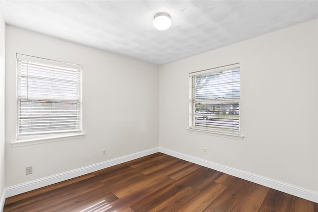 4109 Timberline Dr, Garland, TX 75042 - spare room featuring baseboards and dark wood-type flooring