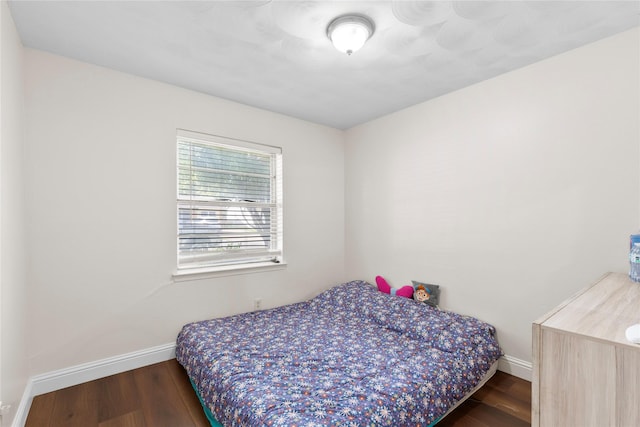 4109 Timberline Dr, Garland, TX 75042 - bedroom featuring baseboards and wood finished floors