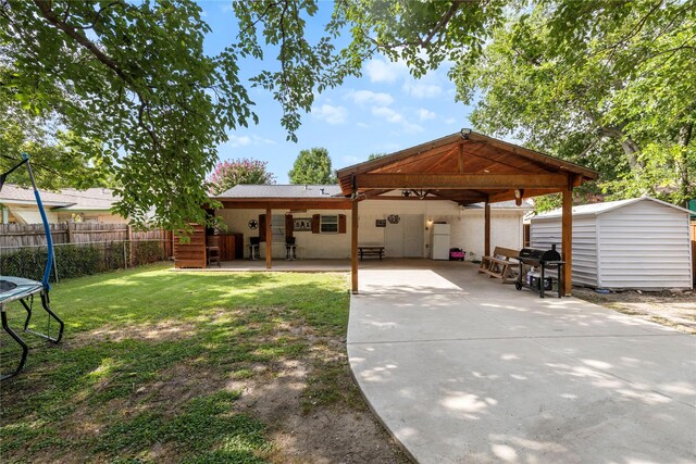 4109 Timberline Dr, Garland, TX 75042 - rear view of property featuring a patio area, stucco siding, a storage unit, concrete driveway, and a carport